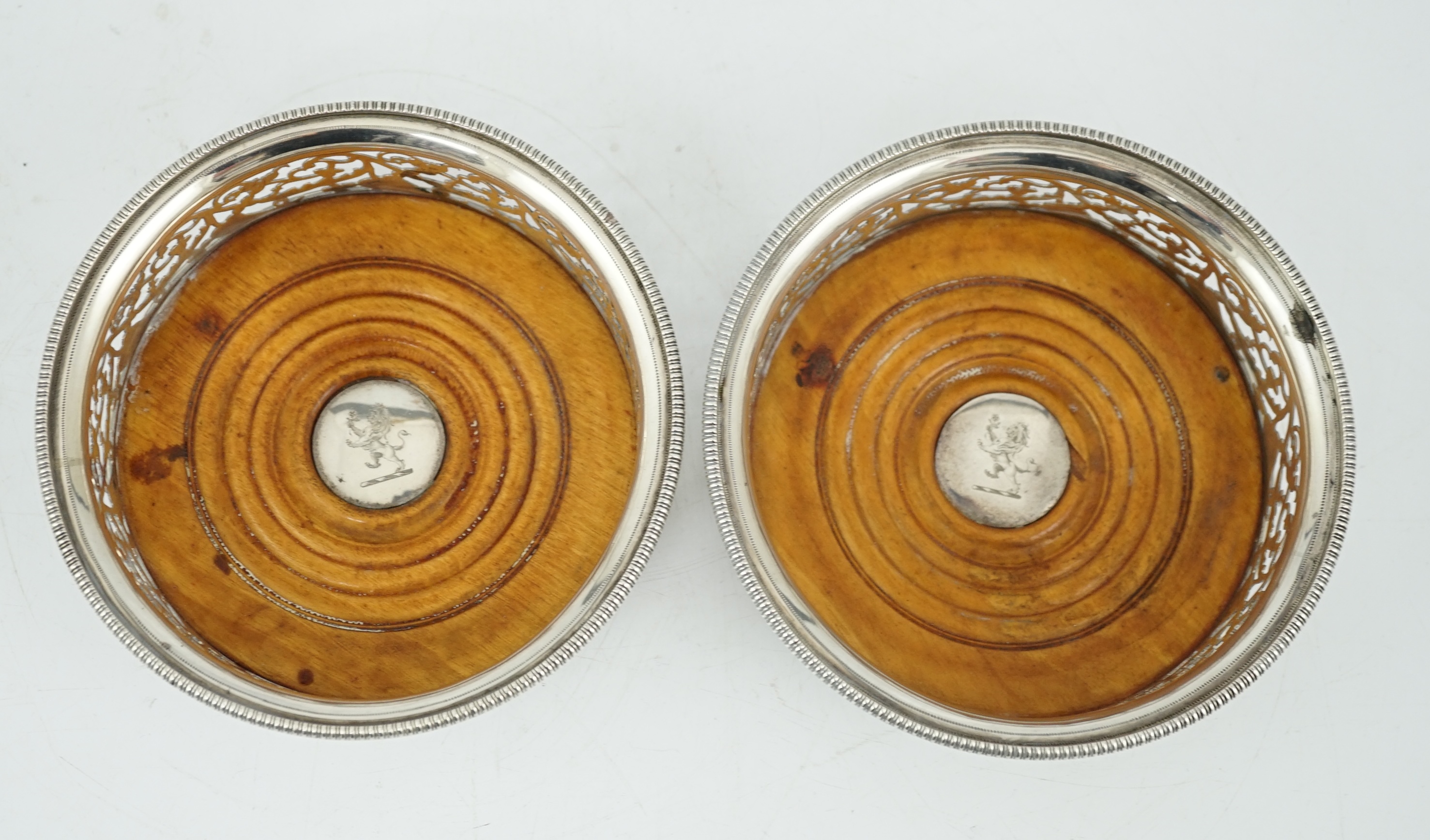 A pair of George III pierced silver mounted wine coasters, William Allen III